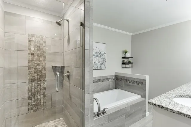 a view of a blue house with yard and sitting area