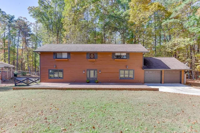a view of a hallway with wooden floor and closet