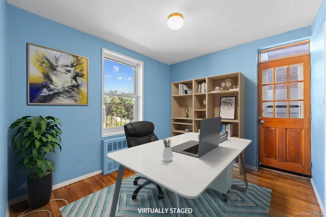 a view of a workspace with furniture and window