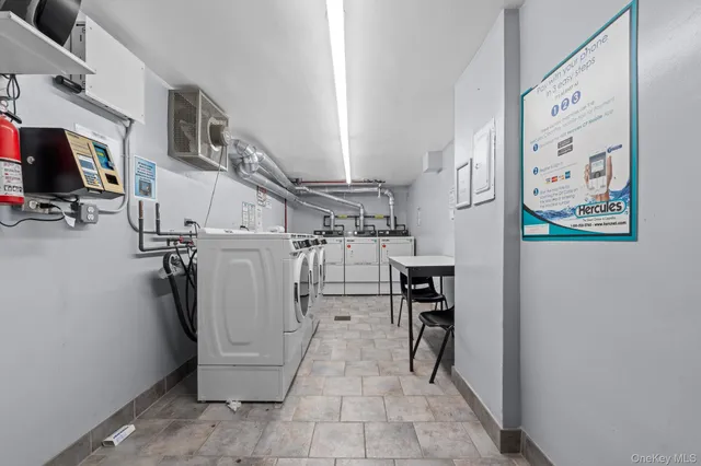 a utility room with multiple dryer and washer