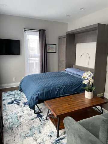 a bedroom with a bed and flat screen tv