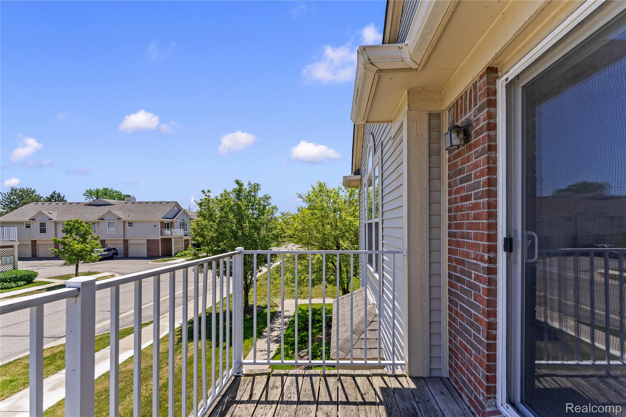 1861 Flagstone Circle Rochester, MI 48307 - Photo 8 of 21 Private balcony with wood-finish decking and white metal railing