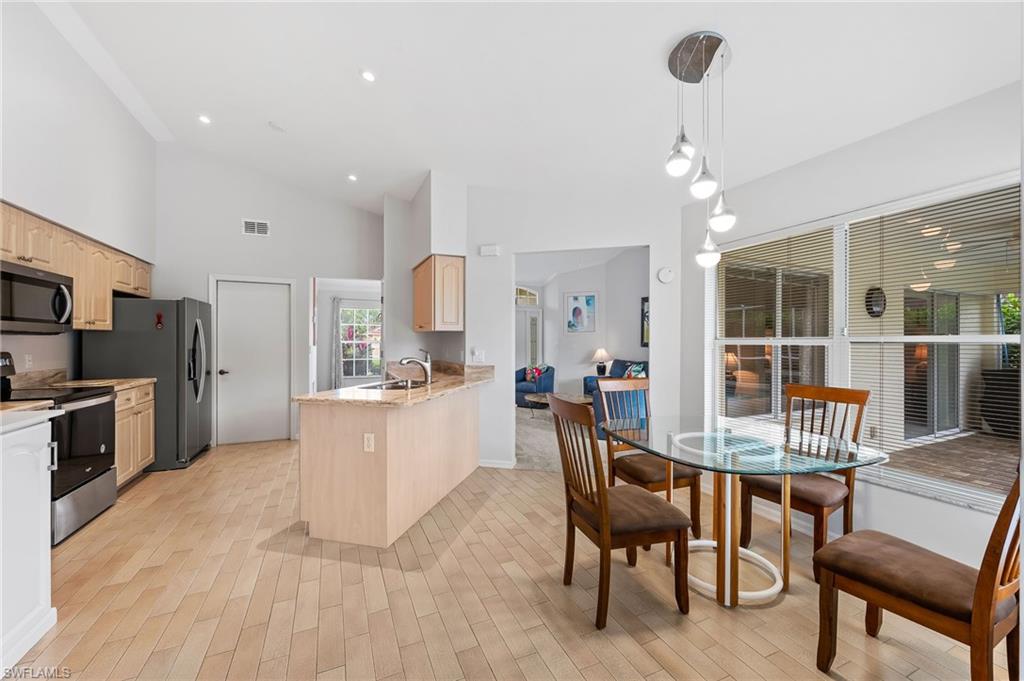 511 Ibis Way Naples, FL 34110 - Photo 13 of 46 a large kitchen with a table and chairs