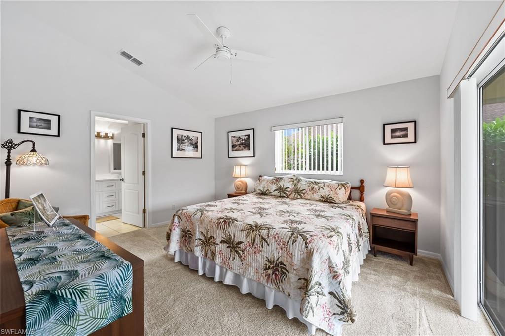 511 Ibis Way Naples, FL 34110 - Photo 19 of 46 a bedroom with a bed and a chandelier