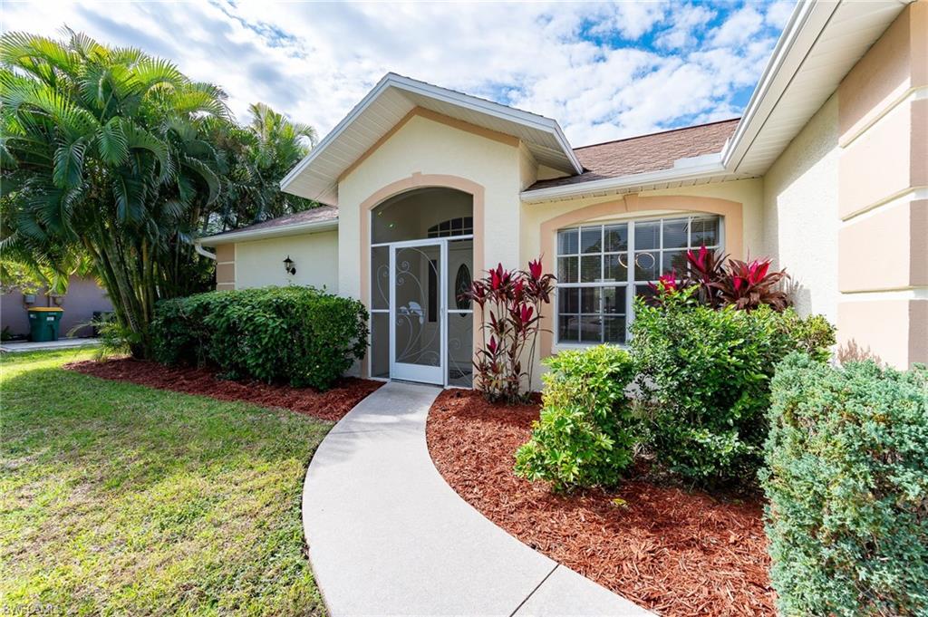 511 Ibis Way Naples, FL 34110 - Photo 2 of 46 a front view of a house with garden