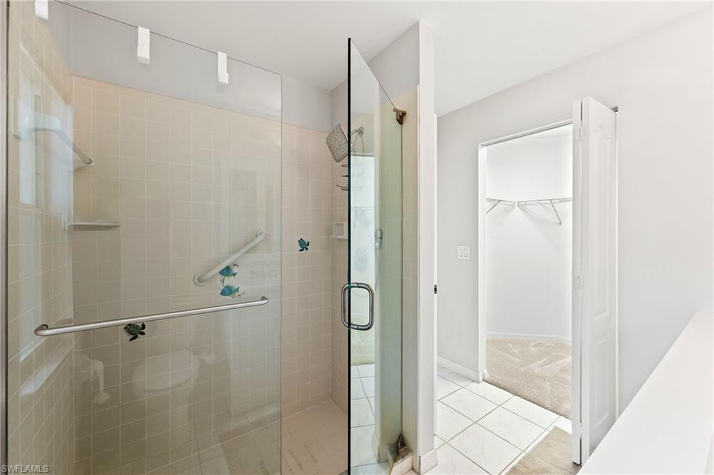 511 Ibis Way Naples, FL 34110 - Photo 24 of 46 a bathroom with a shower and a glass door