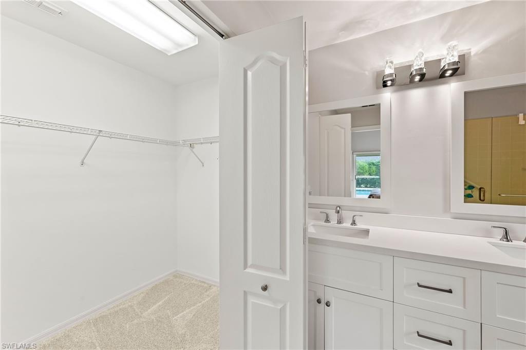 511 Ibis Way Naples, FL 34110 - Photo 25 of 46 a bathroom with a sink and a mirror