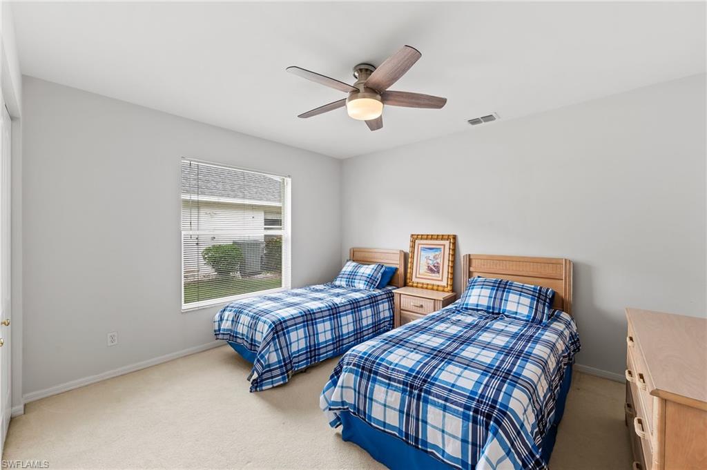 511 Ibis Way Naples, FL 34110 - Photo 29 of 46 a bedroom with two beds and window