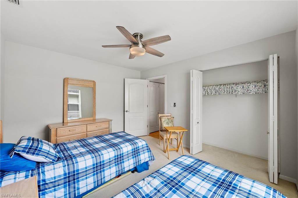 511 Ibis Way Naples, FL 34110 - Photo 30 of 46 a bedroom with a bed and a window