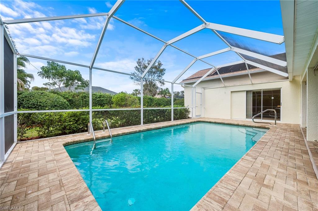 511 Ibis Way Naples, FL 34110 - Photo 35 of 46 a view of a backyard with a swimming pool