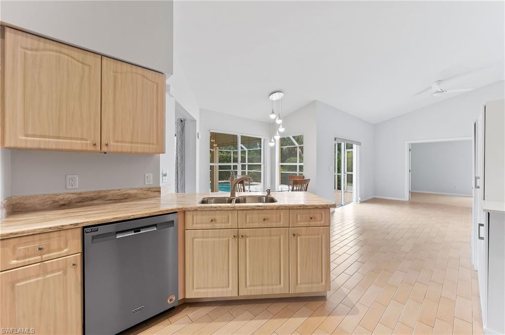 511 Ibis Way Naples, FL 34110 - Photo 10 of 46 a kitchen with granite countertop a sink and cabinets