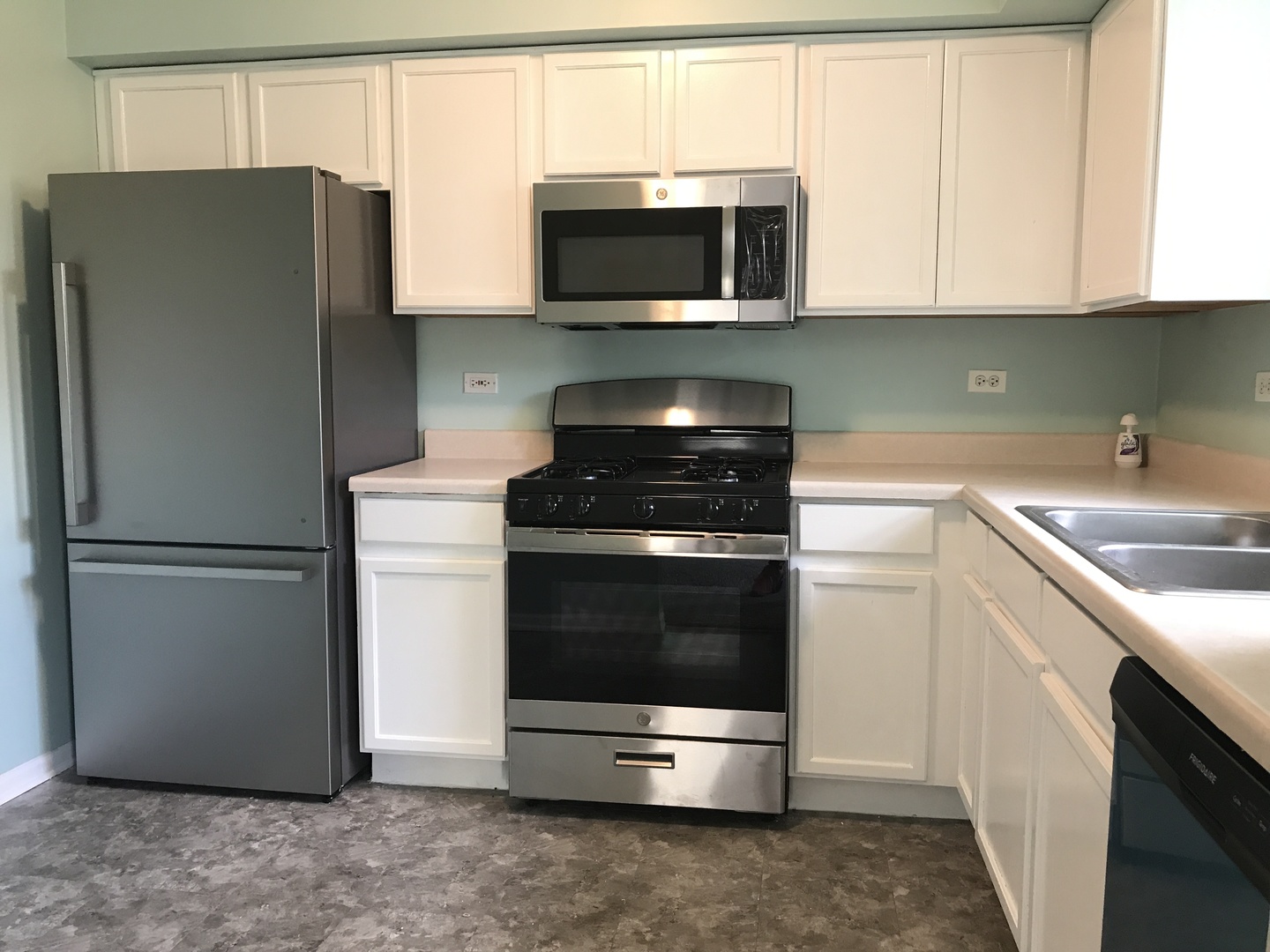 237 North Mill Road, Unit 2 Addison, IL 60101 - Photo 14 of 39 a kitchen with stainless steel appliances and cabinets