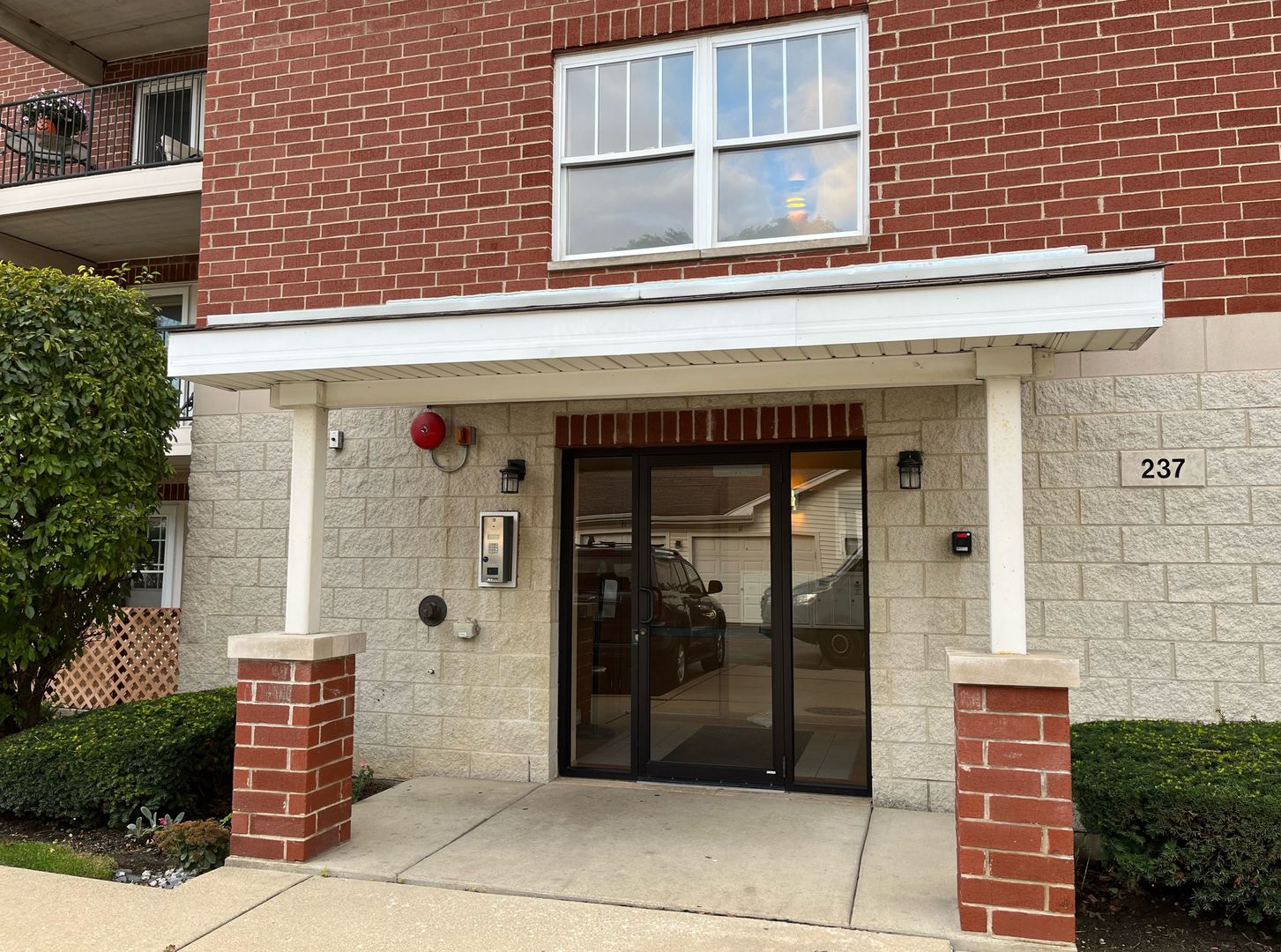 237 North Mill Road, Unit 2 Addison, IL 60101 - Photo 3 of 39 a front view of a building with glass windows and door