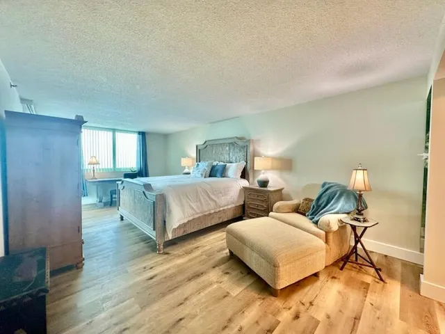a living room with couches and a night stand