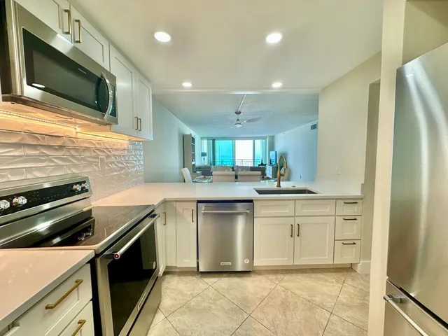 a kitchen with a sink stainless steel appliances and cabinets