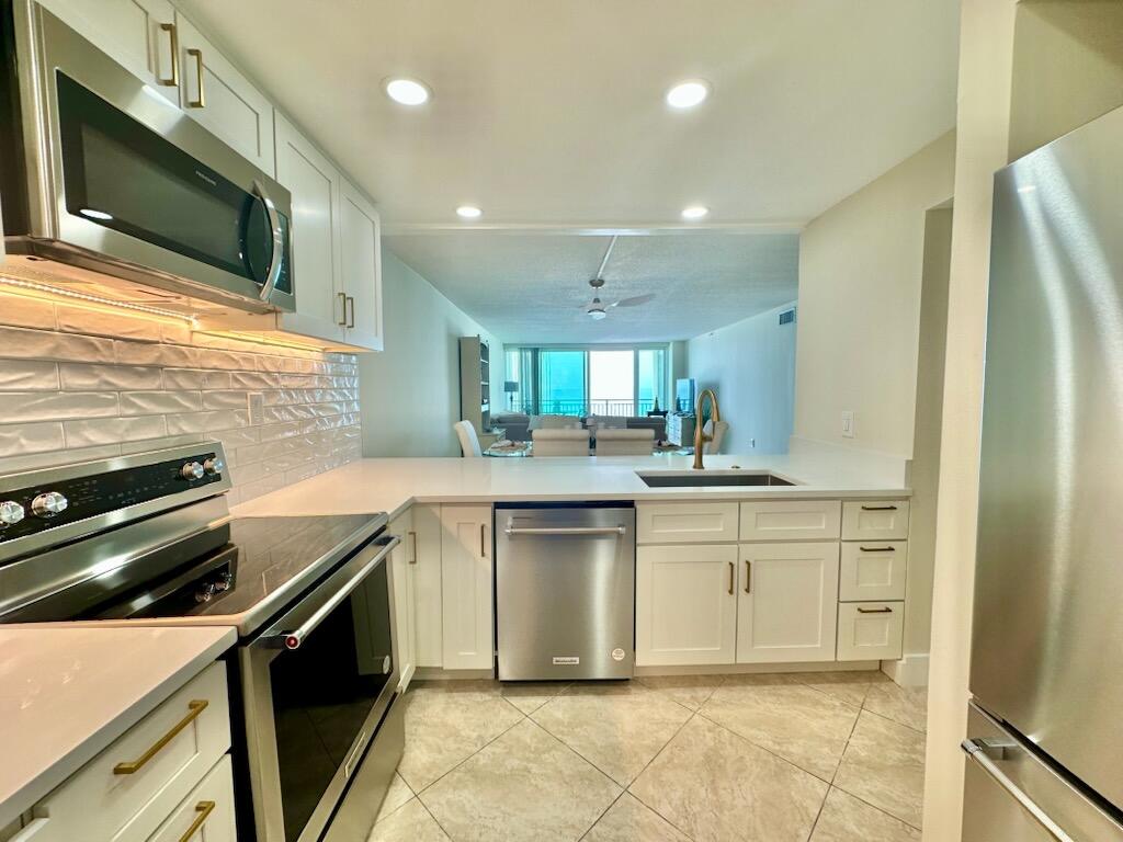 381 Santa Rosa Boulevard, Unit 709 Fort Walton Beach, FL 32548 - Photo 12 of 20 a kitchen with a sink stainless steel appliances and cabinets