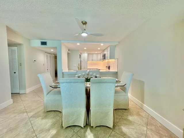 a dining room with furniture and a chandelier