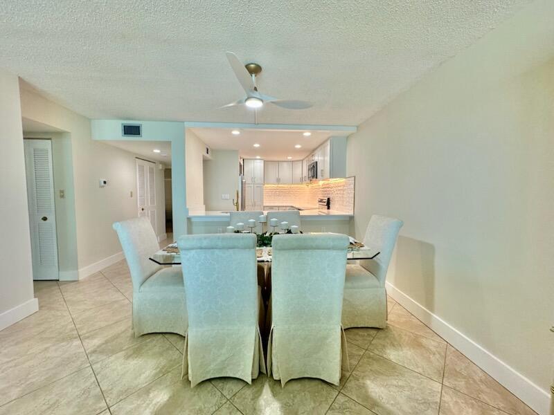 381 Santa Rosa Boulevard, Unit 709 Fort Walton Beach, FL 32548 - Photo 14 of 20 a dining room with furniture and a chandelier