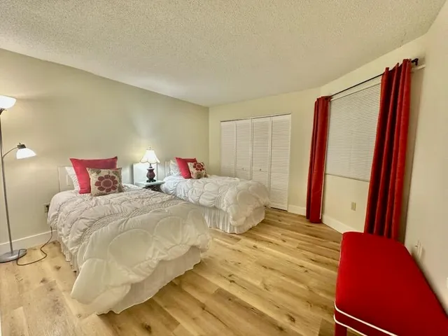 a bedroom with a bed and a flat screen tv