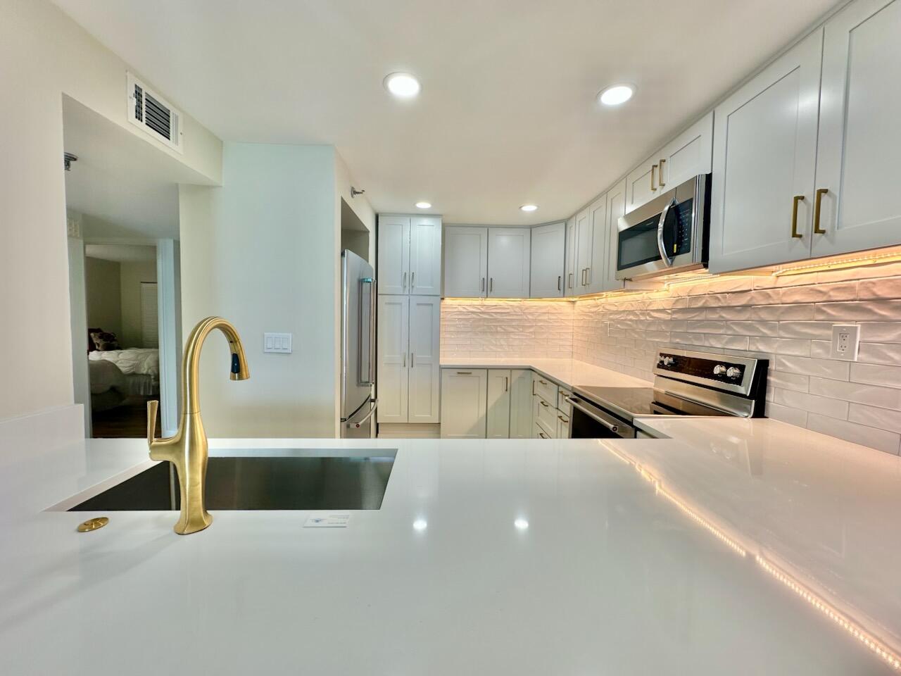 381 Santa Rosa Boulevard, Unit 709 Fort Walton Beach, FL 32548 - Photo 6 of 20 a large kitchen with stainless steel appliances a large counter top