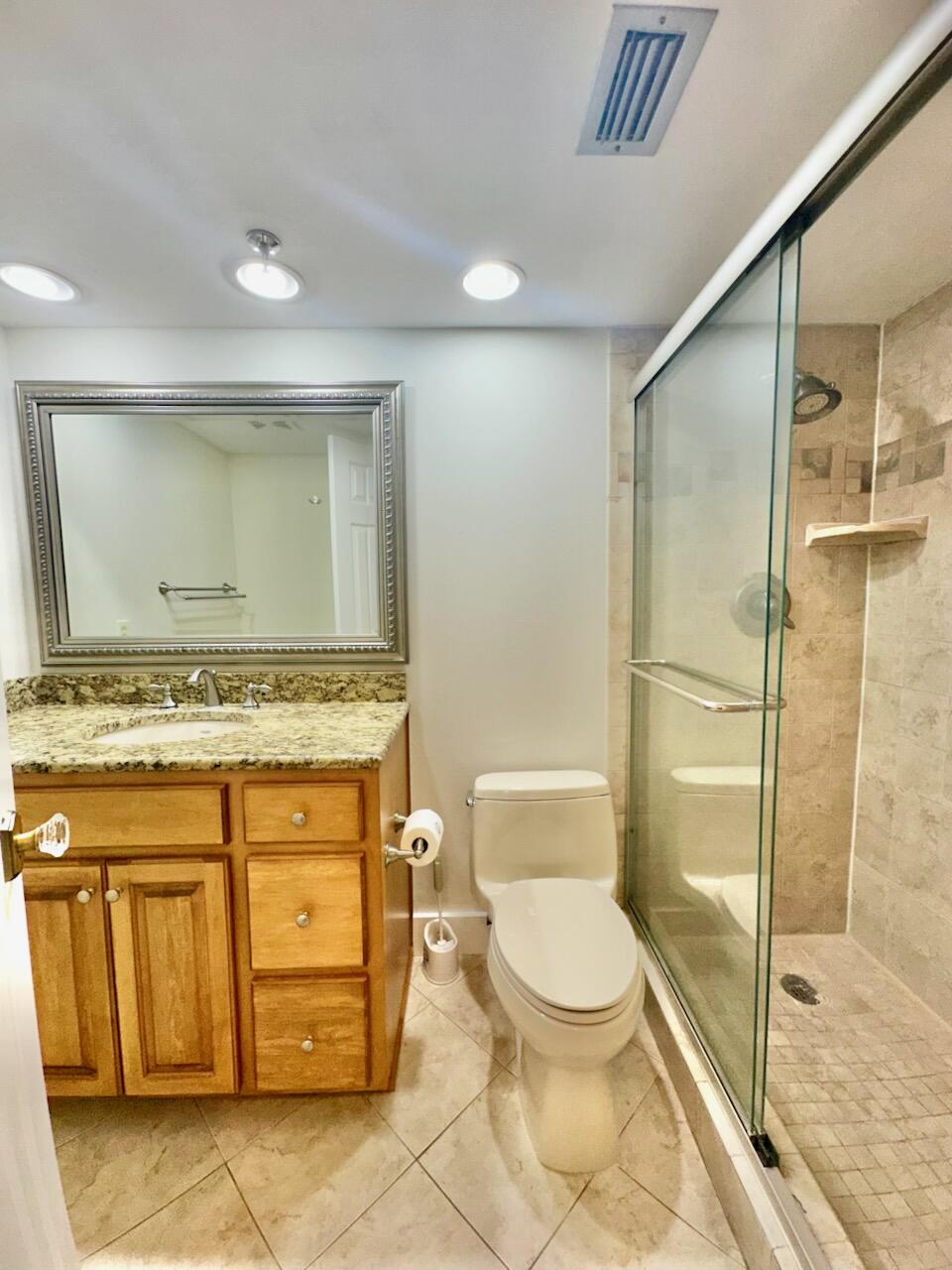 381 Santa Rosa Boulevard, Unit 709 Fort Walton Beach, FL 32548 - Photo 10 of 20 a bathroom with a granite countertop sink toilet and shower