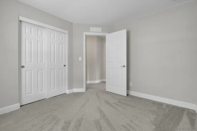 an empty room with closet area