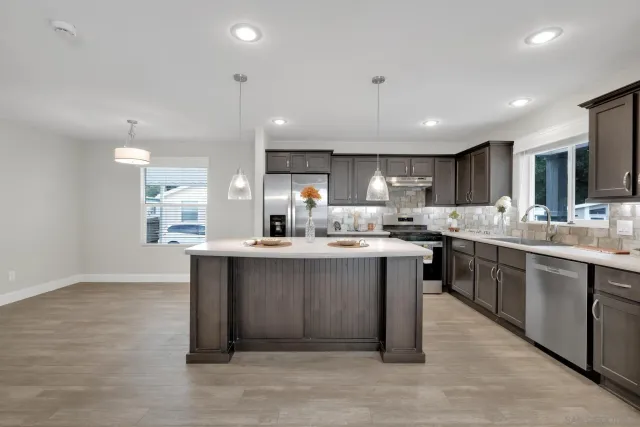 a kitchen with counter top space sink and center island