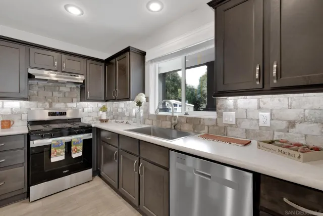 a kitchen with a sink stove and cabinets