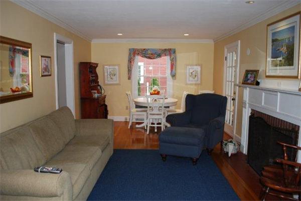 8 Thornton Road Waltham, MA 02453 - Photo 4 of 17 a living room with furniture a fireplace and a large window