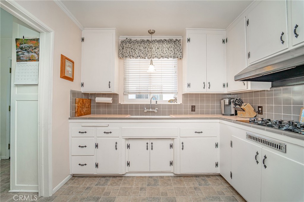 15212 Elmbrook Drive La Mirada, CA 90638 - Photo 15 of 51 a kitchen with granite countertop white cabinets and white appliances