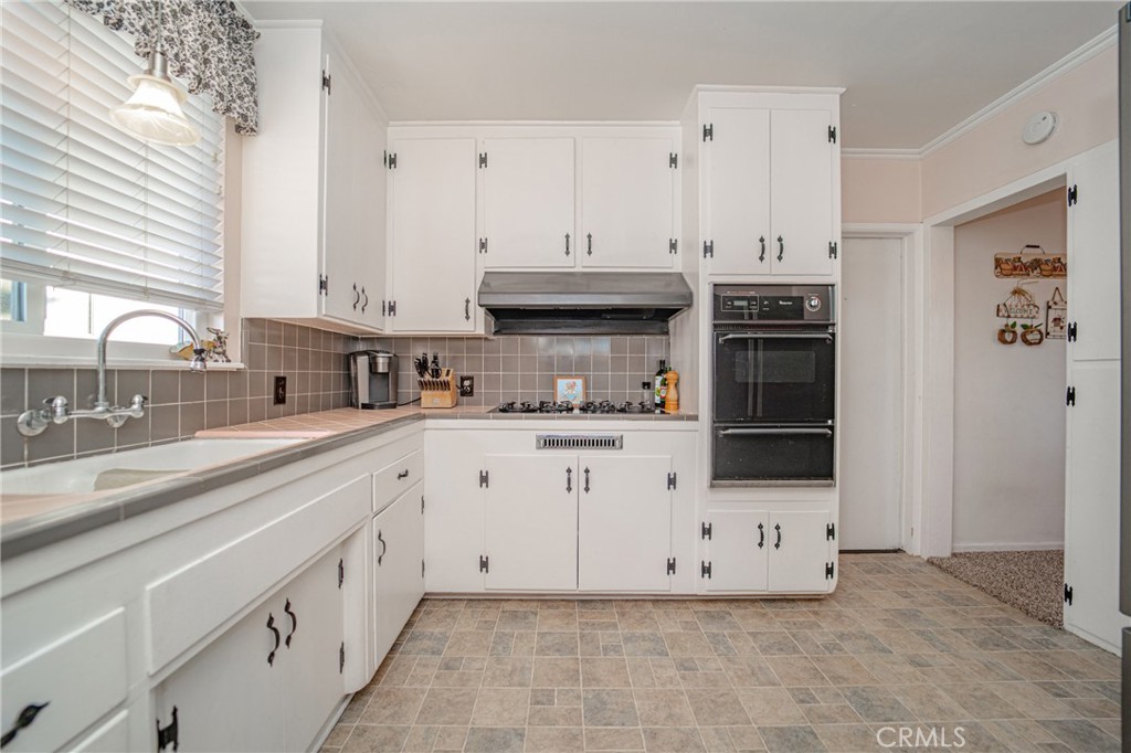 15212 Elmbrook Drive La Mirada, CA 90638 - Photo 16 of 51 a kitchen with stainless steel appliances a sink stove and cabinets