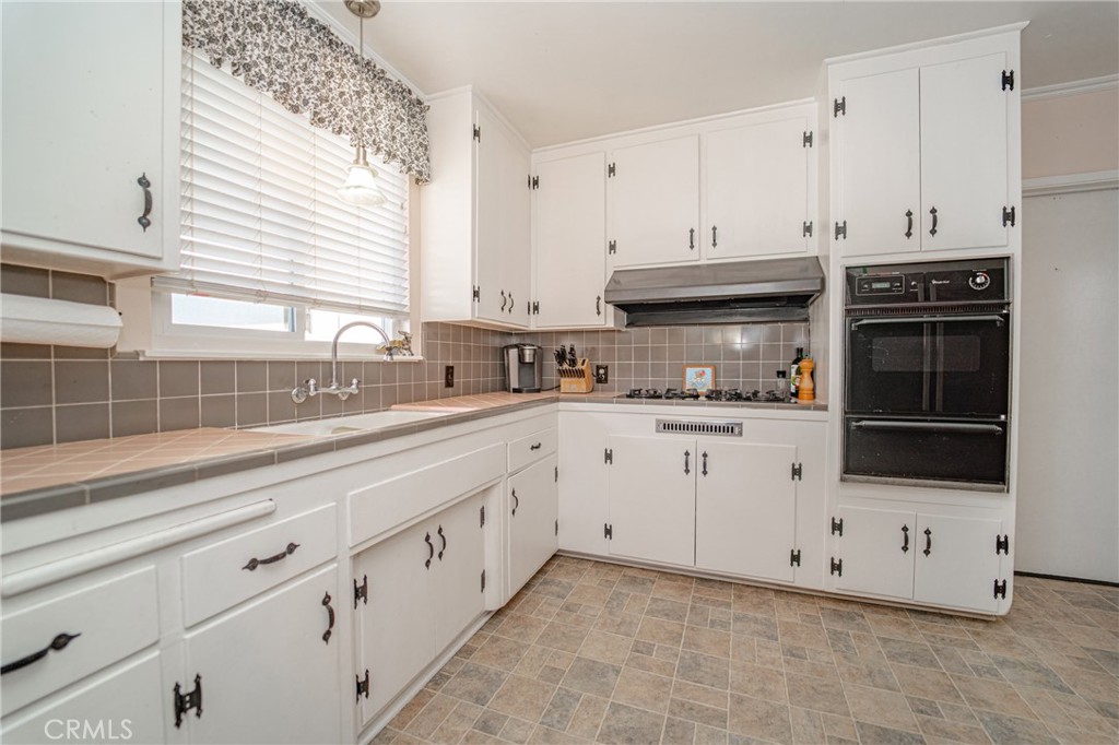 15212 Elmbrook Drive La Mirada, CA 90638 - Photo 17 of 51 a kitchen with stainless steel appliances white cabinets and a sink