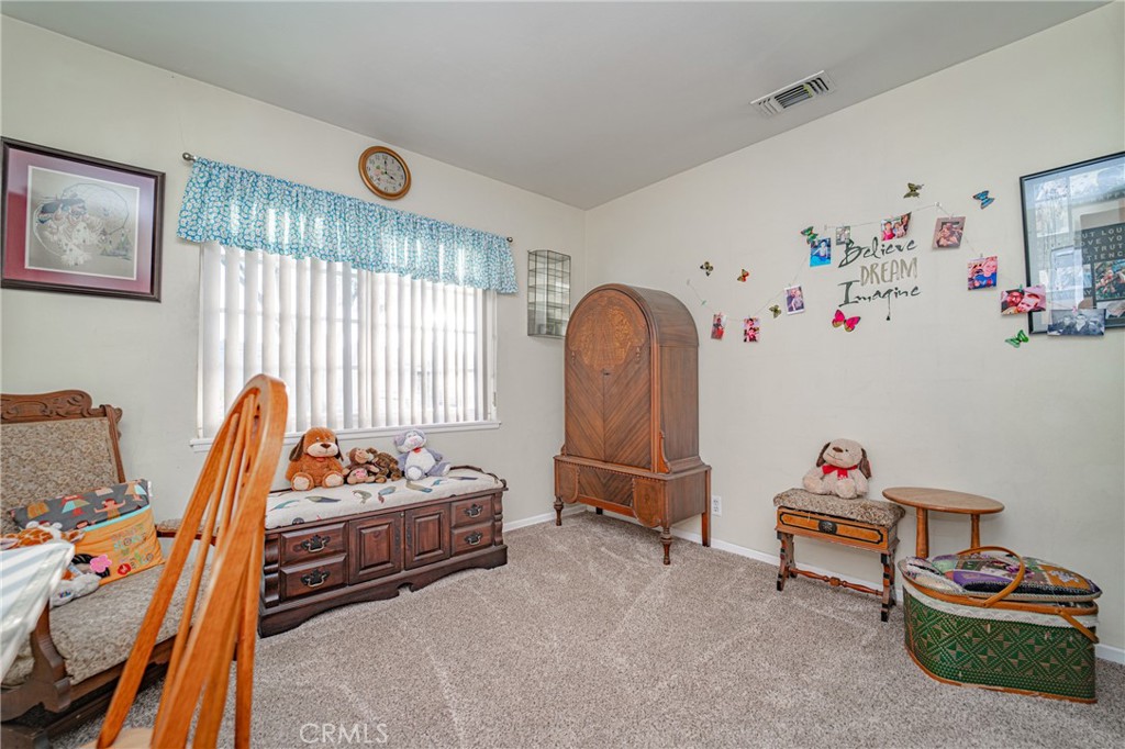 15212 Elmbrook Drive La Mirada, CA 90638 - Photo 24 of 51 a living room with baby crib furniture and a window