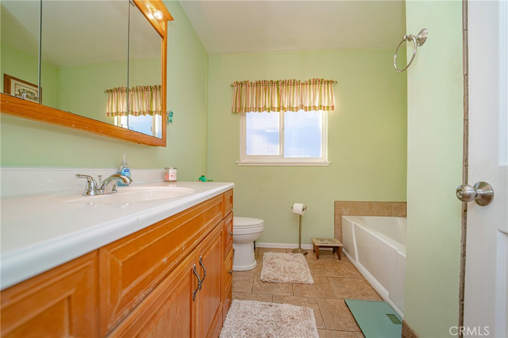 15212 Elmbrook Drive La Mirada, CA 90638 - Photo 35 of 51 a bathroom with a granite countertop sink toilet and shower