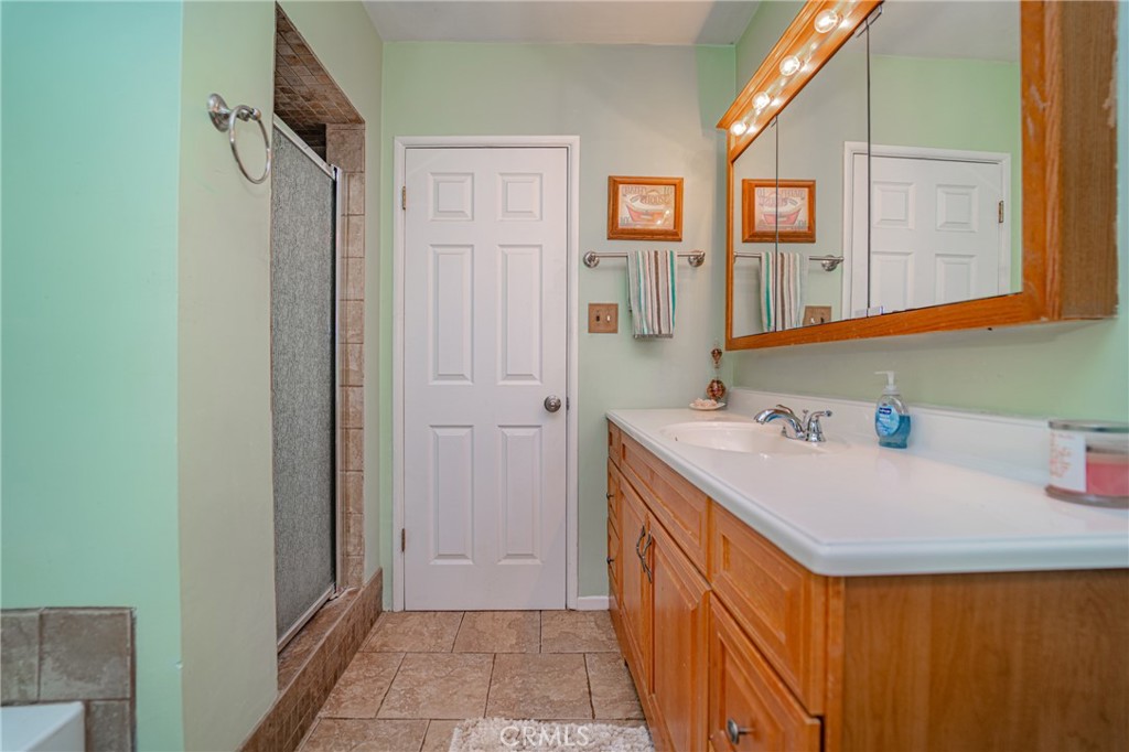15212 Elmbrook Drive La Mirada, CA 90638 - Photo 37 of 51 a bathroom with a sink a mirror and a shower