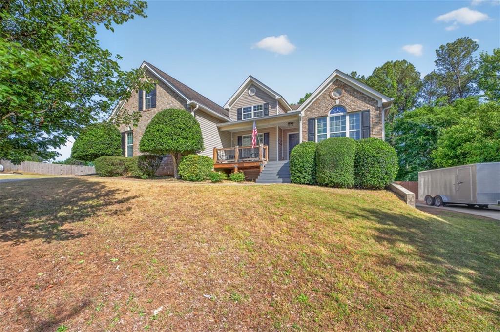 89 Katie Spring Lane Jefferson, GA 30549 - Photo 8 of 63 a front view of a house with a yard and garage