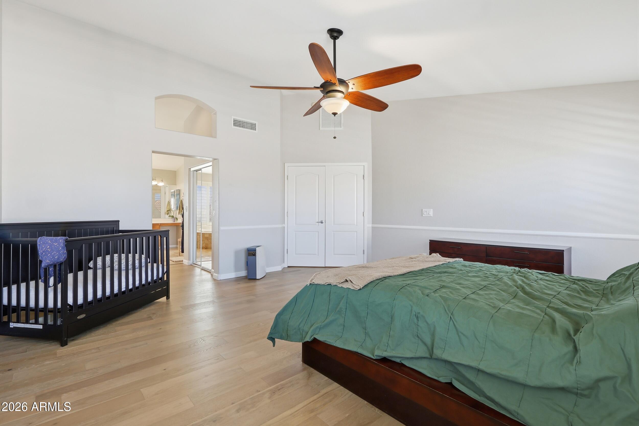 14025 South 44th Street Phoenix, AZ 85044 - Photo 27 of 52 a bedroom with a bed and cabinets