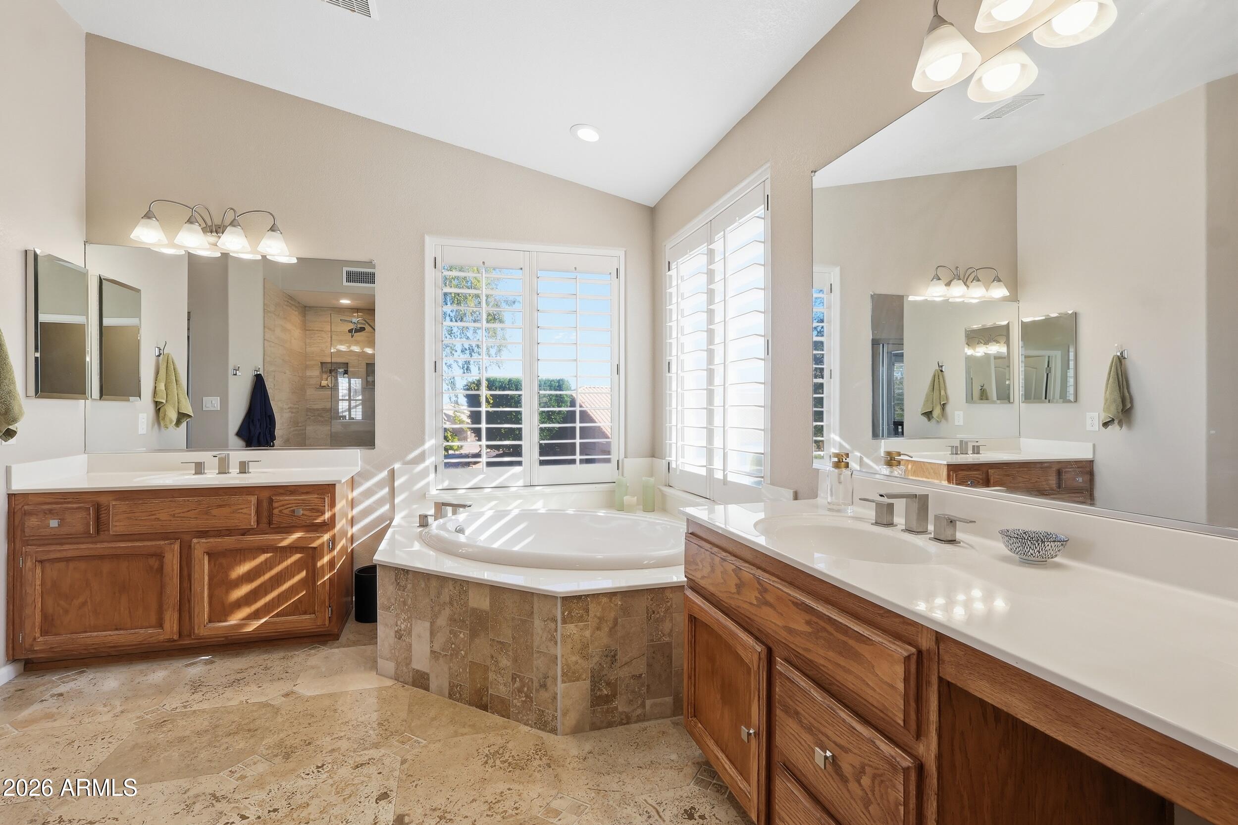 14025 South 44th Street Phoenix, AZ 85044 - Photo 31 of 52 a spacious bathroom with a tub sink and mirror