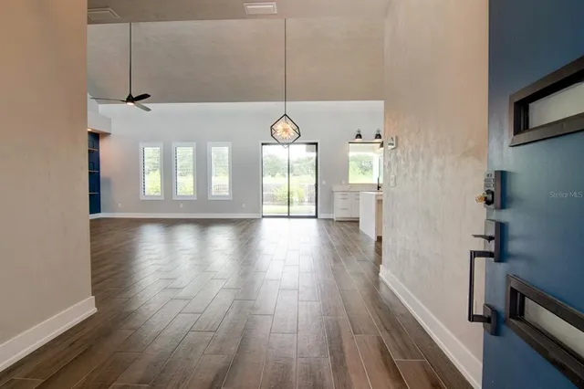 a view of a room with wooden floor