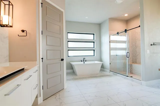 a bathroom with a bathtub and shower