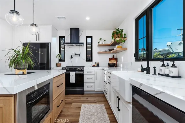 a kitchen with a sink counter top space appliances and cabinets