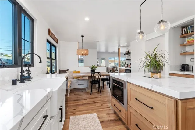 a kitchen with kitchen island white cabinets and white appliances