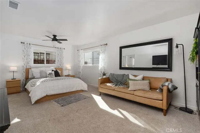 a spacious bedroom with a bed and window