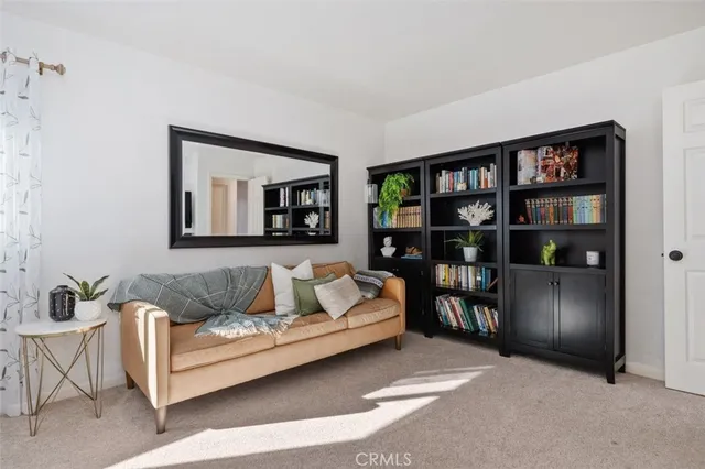 a living room with furniture and a book shelf