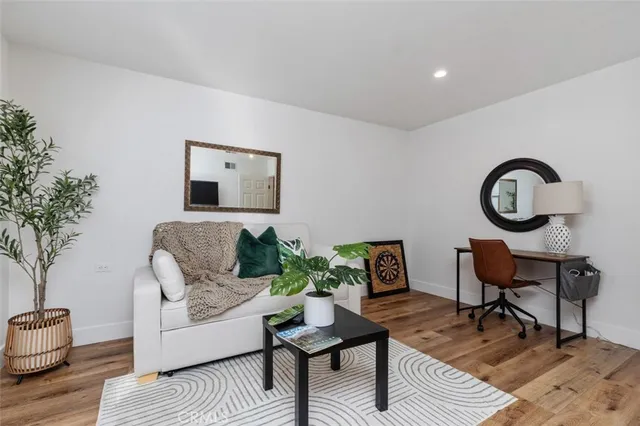 a living room with furniture and a potted plant