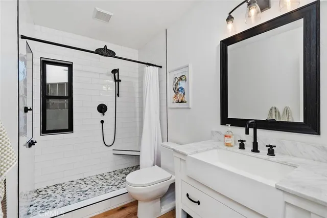 a bathroom with a sink toilet and shower