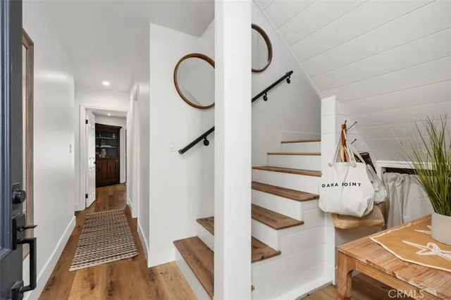 a view of entryway and hall with wooden floor