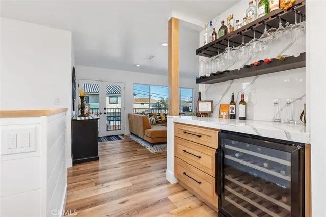 a kitchen with cabinets and wooden floor