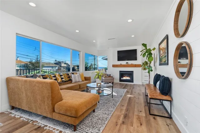 a living room with furniture a fireplace and a flat screen tv