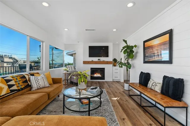 a living room with furniture a flat screen tv and a fireplace